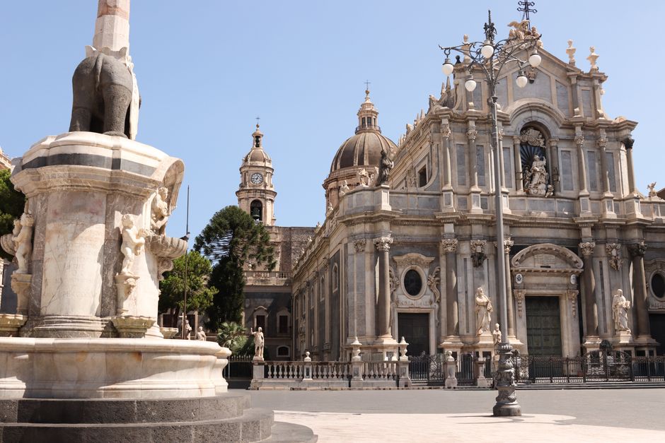 A stunning view of baroque architecture with cloudy skies captured at dusk in the Italian Piazza.