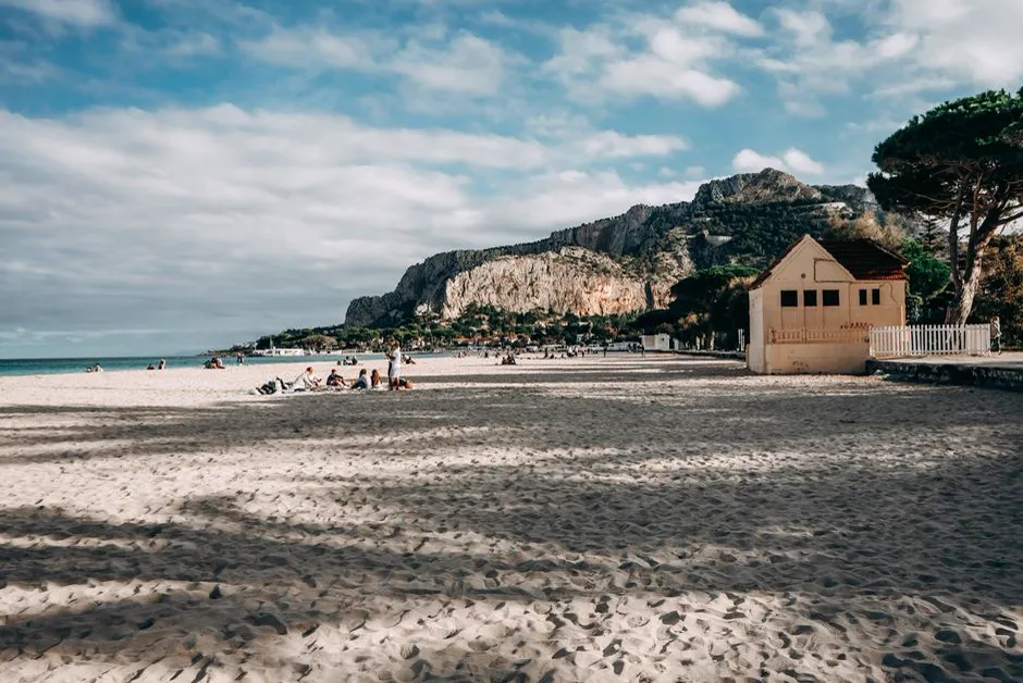 Mondello beach near Palermo, Sicily, with its sandy shore, liberty-style bathhouse, and Monte Pellegrino in the background
