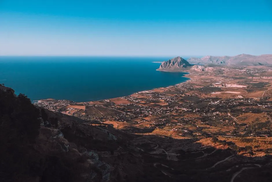 Aerial view of San Vito Lo Capo, Sicily, with its curved white-sand bay and Monte Monaco in the background