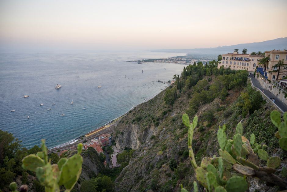 A breathtaking view of the Sicilian coastline from Taormina at sunset.