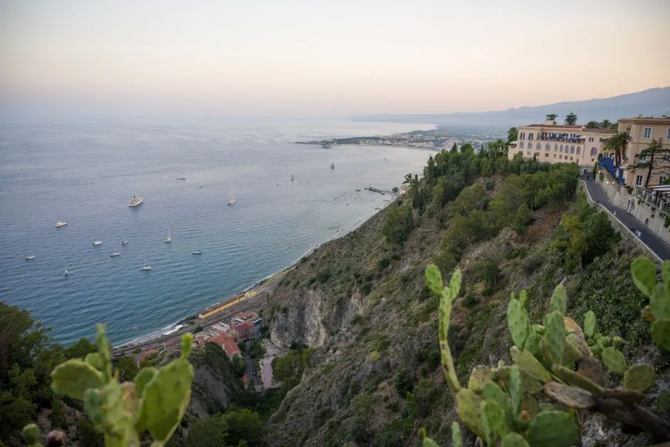 A breathtaking view of the Sicilian coastline from Taormina at sunset.