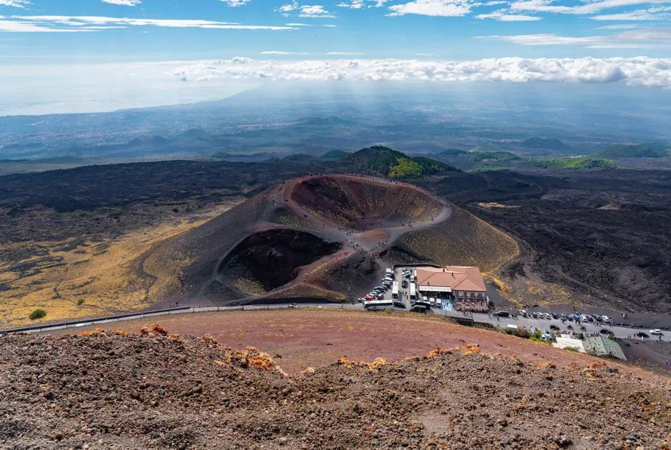 Stunning aerial view of Mount Etna's craters and landscape in Sicily, captured under a clear blue sky.