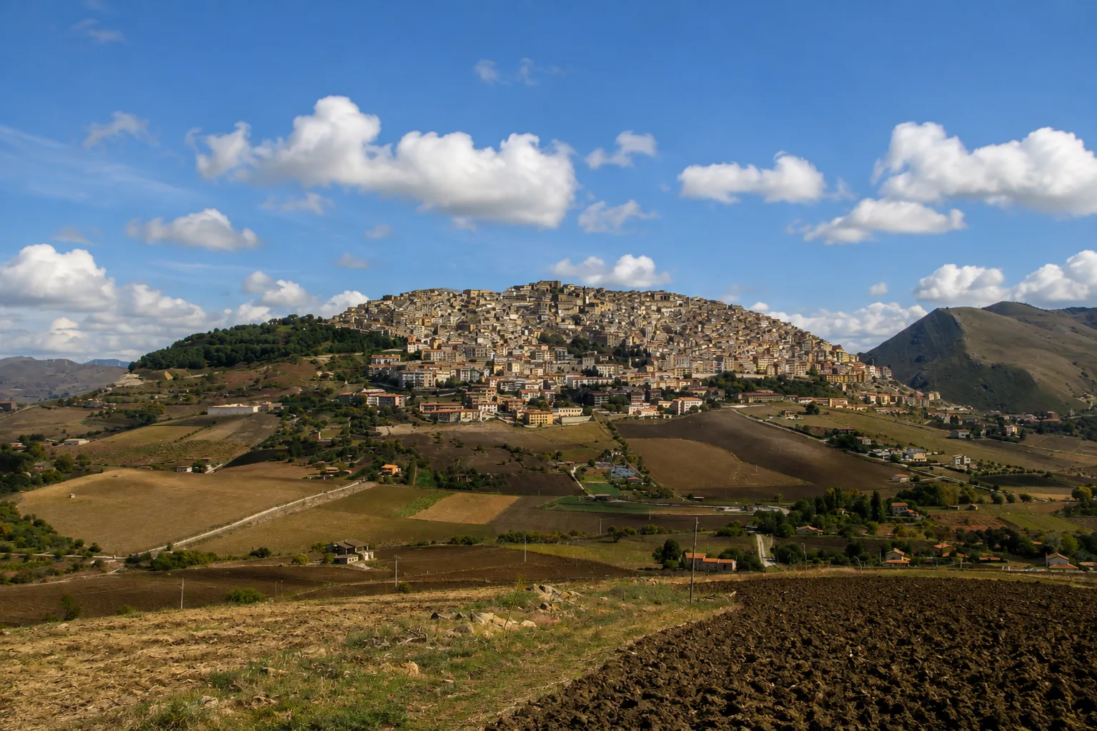 The hilltop town of Gangi in the Madonie mountains, stone houses climbing toward the Ventimiglia tower at the summit.