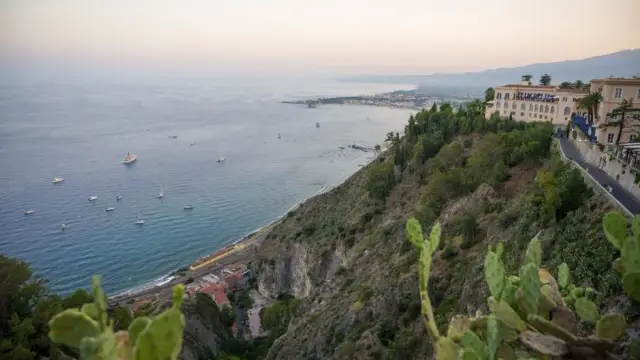 A breathtaking view of the Sicilian coastline from Taormina at sunset.