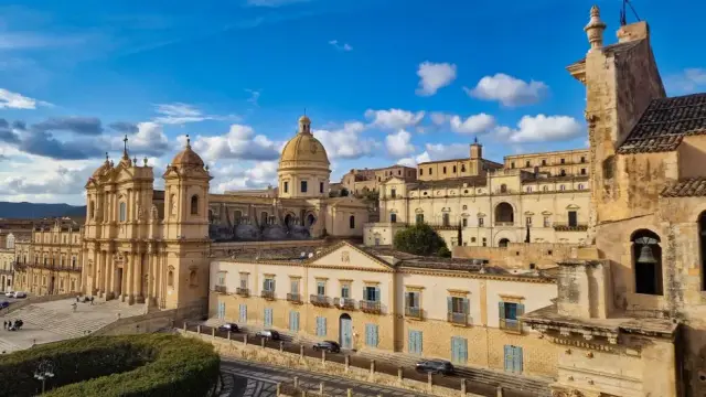 Beautiful view of the historic Noto Cathedral in Sicily, showcasing its baroque architecture against a vibrant sky.