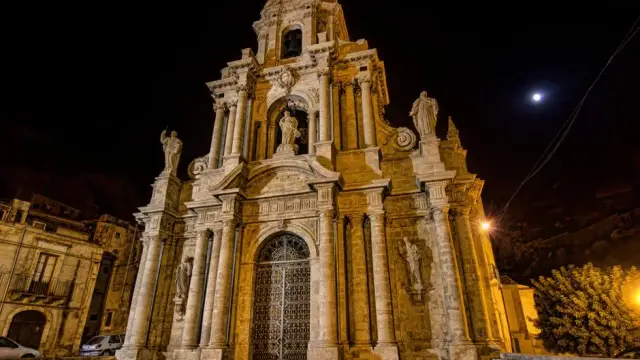 Majestic facade of St Bartholomew's Church in Scicli, Sicily, captured at night with illuminated architectural details.