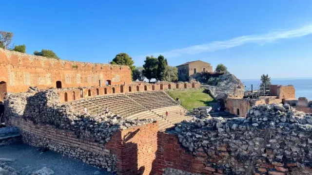 Explore the ancient Greek Theatre in Taormina, Sicily with stunning Mediterranean views.