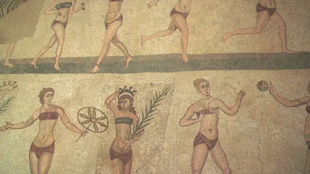 Detail of the famous "Bikini Girls" mosaic at Villa Romana del Casale, showing Roman women in athletic wear performing sports.