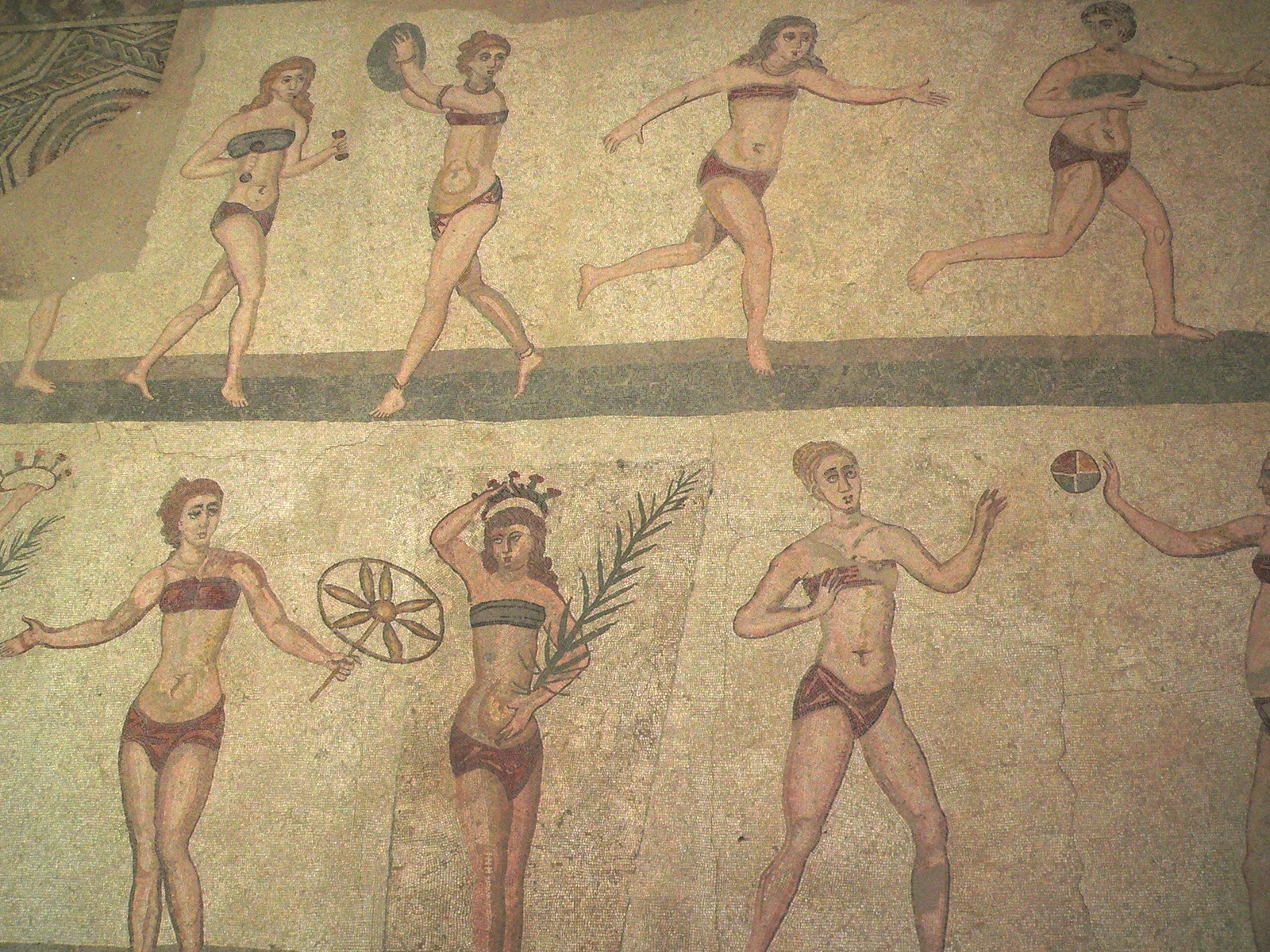 Detail of the famous "Bikini Girls" mosaic at Villa Romana del Casale, showing Roman women in athletic wear performing sports.